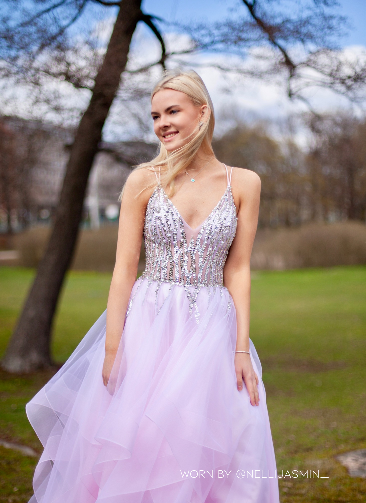 Pinkki vanhojentanssimekko kirjailtulla yläosalla ja röyhelöhelmalla.
